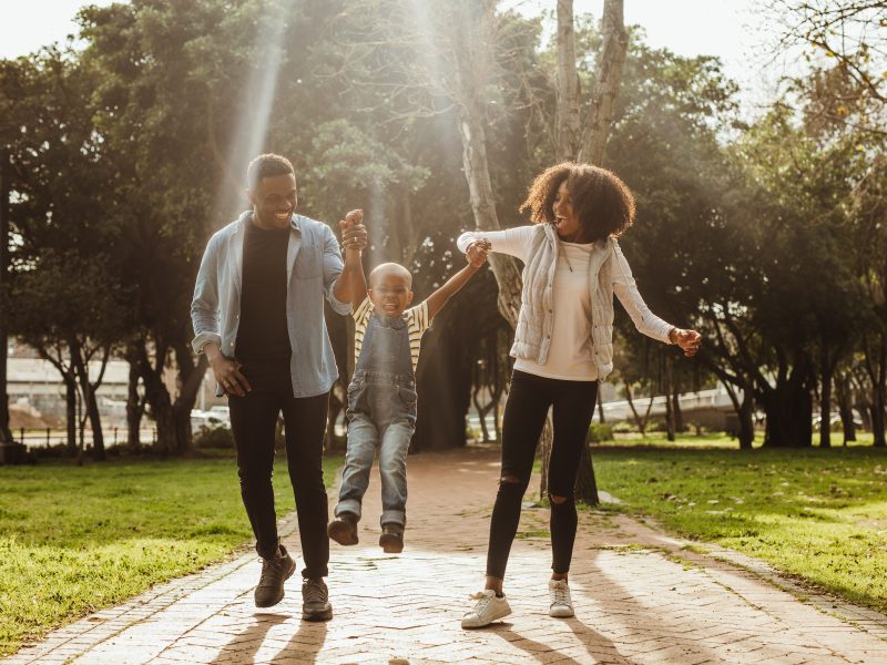 Young family walking together in a park